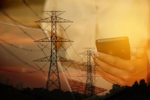 Sunset over high-voltage power lines and mobile communication, blending tec.. Stock Photos