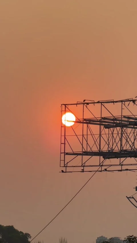 Sunset Over a Highway Billboard, Capturing the Warm Glow of the Setting Sun Stock Footage 335308903
