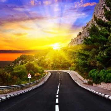 Sunset over the highway Stock Photos