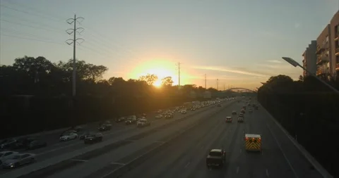 Sunset over highway traffic Stock Footage