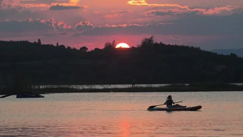 Sunset over Hill with Kayaker on Lake Stock-Footage 345041694
