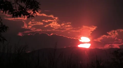 Sunset over the hill. Sunset, the sun is red in the sky, a colorful and cloud  Stock Footage 59842518