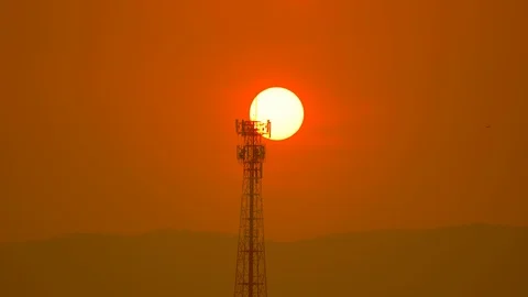 Sunset over hills and antenna tower on golden sunshine sky background 스톡 동영상 127405180