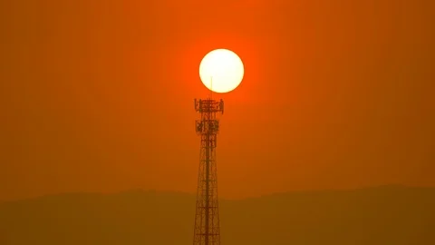 Sunset over hills and antenna tower on golden sunshine sky background Stock-Footage 127405258