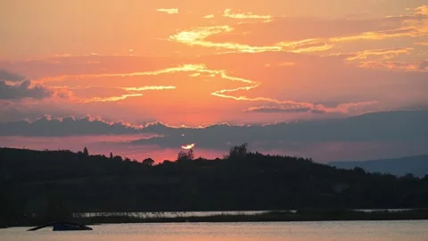 Sunset over Hills and Lake with Orange Sky Stock-Footage 345033981
