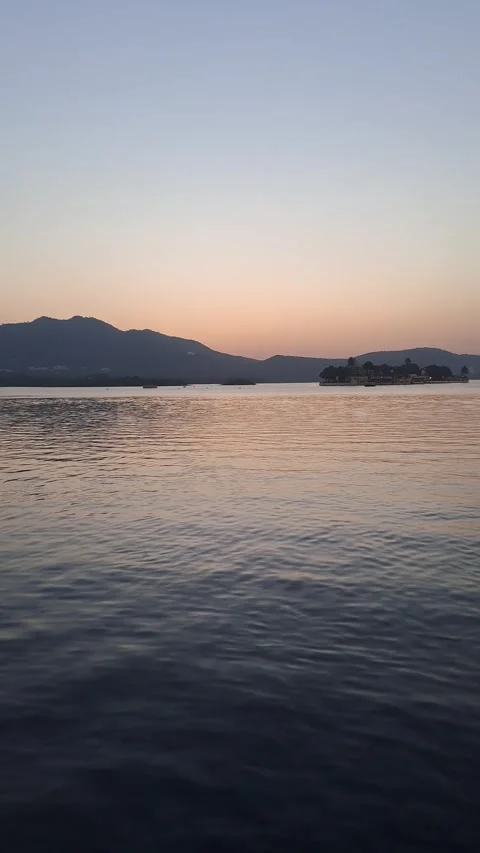 Sunset over hills behind the Lake Pichola in Udaipur Stock Footage 260227257