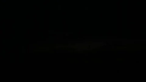Sunset over the hills. In the foreground are silhouettes of bushes and flowers. Stock Footage 322150223