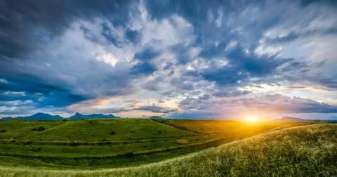 Sunset over hills Stock Photos