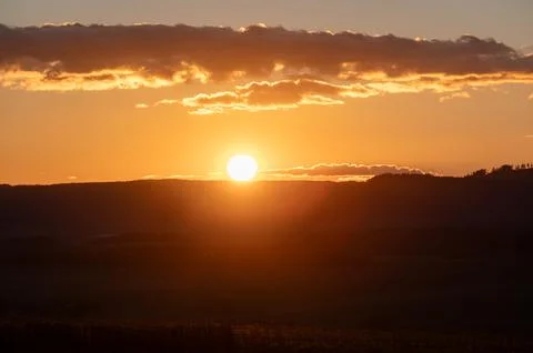Sunset over the horizon with dramatic clouds in the sky, painting warm tone.. Stock-Fotos