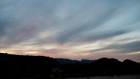 Sunset over the horizon with whispy clouds changing colour 4K Time Lapse Video stock 337558239