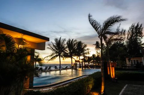 Sunset over  hotel pool. Stock Photos