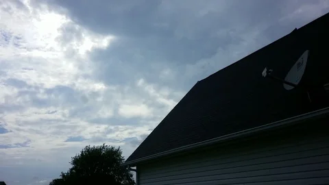 Sunset over house with rolling clouds Stock Footage 94431808