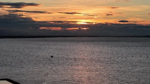 Sunset over Hue lagoon with bridge and fish farms aerial 4K Stock Footage 339864456
