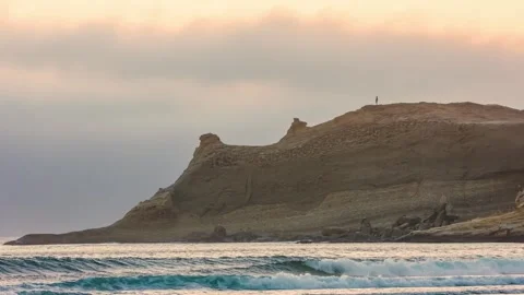 Sunset over the iconic Cape Kiwanda dory boat launch area and large sand dune in Stock Footage 326709078