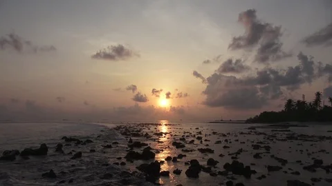 Sunset over the Indian Ocean, reefs at low tide. Maldives video Stock Footage 88411179