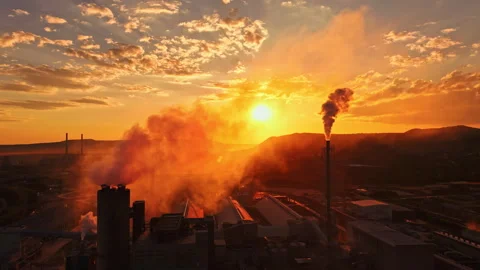Sunset over an industrial area with smoke and clouds in the sky and colorful Stock Footage 340961270