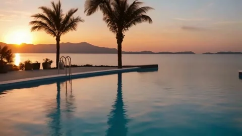 Sunset Over Infinity Pool With Palm Trees Slow Motion Tracking Video stock 273996672