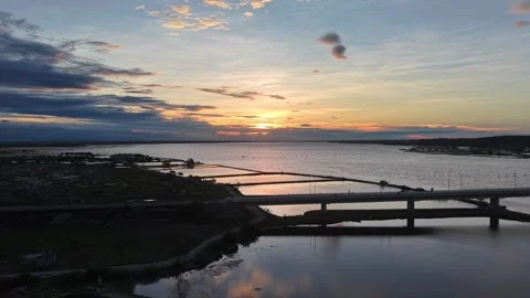Sunset over lagoon with bridge silhouette aerial view 4K Stock Footage 339863895