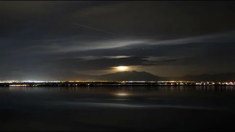 Sunset over the lake against the background of the night city Stock Footage 136842524