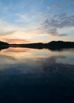 Sunset over the lake and forest Stock Photos