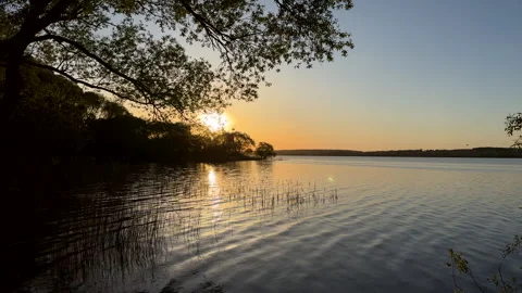 Sunset over the lake. Awesome Sunset with dramatic clouds Stock Footage 276736422