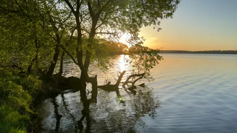 Sunset over the lake. Awesome Sunset with dramatic clouds Stock Footage 276736515
