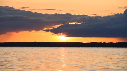 Sunset over the lake in Belarus, the sun behind the clouds Stock Footage 240013398