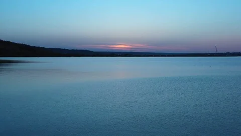 Sunset over the lake, birds fly by Stock Footage 129105589