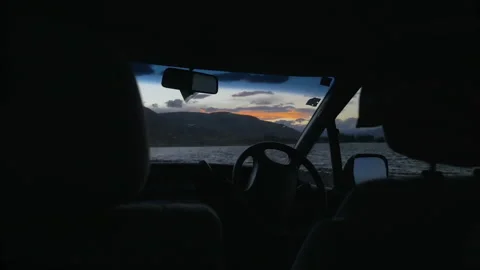 Sunset over Lake Camp from inside a campervan, in New Zealand Stock Footage 211987636