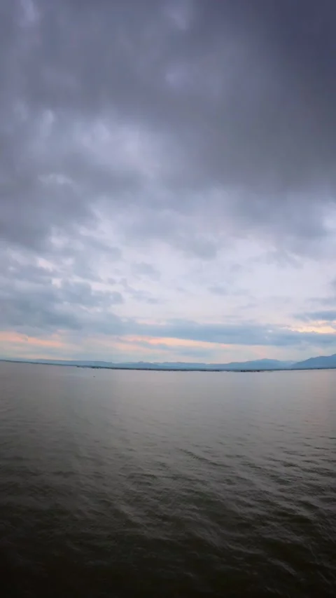 Sunset over the lake in a cloudy day Stock Footage 300347111