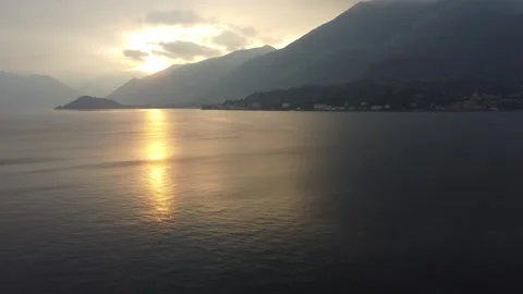 Sunset over Lake Como with Vibrant Orange Sky Stock Footage 313563110