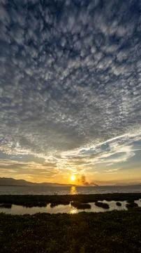 Sunset Over the Lake with Dramatic Clouds Stock-Fotos