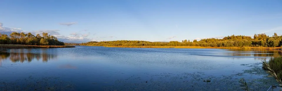 Sunset over lake with fall trees. Sweden. Stock Photos