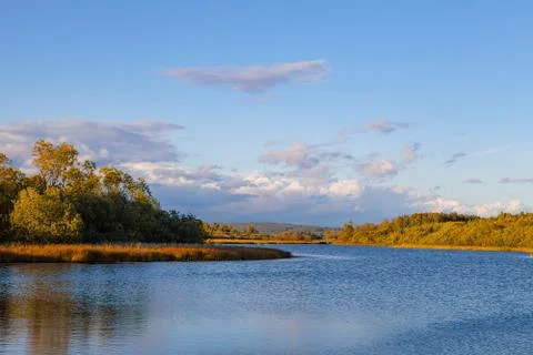 Sunset over lake with fall trees. Sweden. Stock Photos