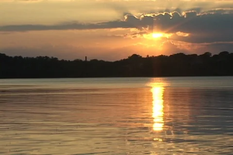 Sunset over lake with long sun reflection Stock Footage 125720583