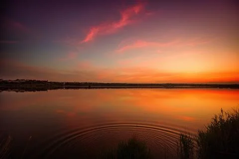 Sunset over the lake with a mirror reflection of the clouds. mirror water Stock Photos