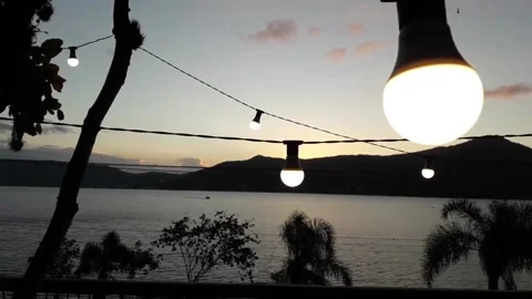 Sunset over the Lake with Modern Light Bulbs Stock Footage 162243789