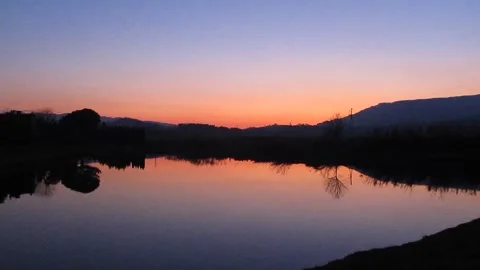 Sunset Over Lake with Mountain Silhouette in Pistoia 库存影片 343476940