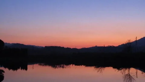 Sunset Over Lake with Mountain Silhouette in Pistoia 库存影片 343476945