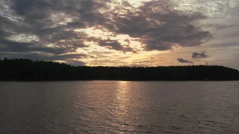 Sunset over the lake, orange clouds in the light of the setting sun Stock Footage 154555491