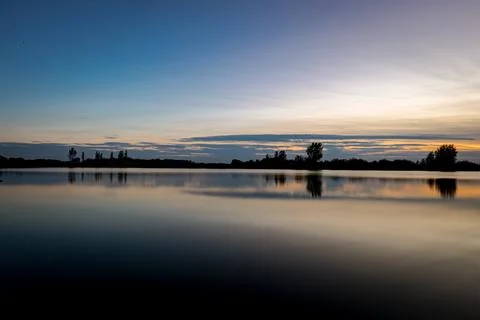 Sunset over lake Stock Photos
