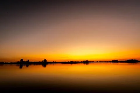 Sunset over lake Stock Photos