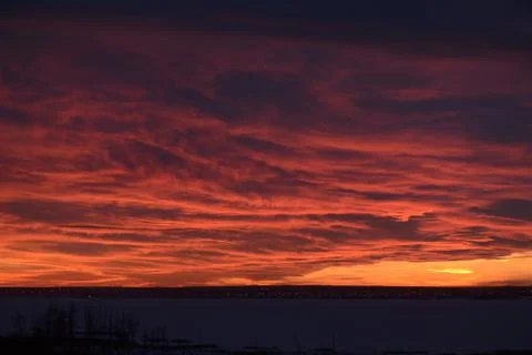 Sunset over the lake, red clouds. winter landscape Stock Photos