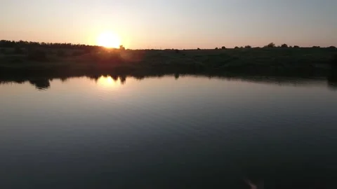 Sunset over the lake. Reflection of a sunset in the water. Stock Footage 161509237