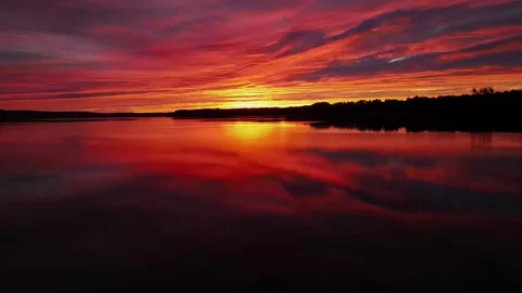 Sunset over lake, reflections, tinted clouds, Movement, Germany, 4K Drone Stock Footage 279759155