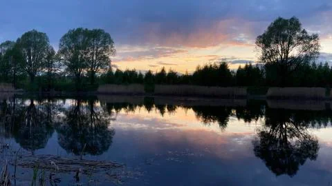 Sunset over the lake in the spring Stock Photos
