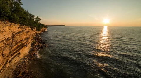 Sunset over lake superior and sandstone cliffs Stock Footage