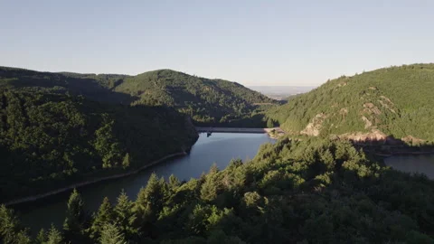 Sunset Over Lake Surrounded by Mountains and Forest with Golden Light Stock Footage 315617427