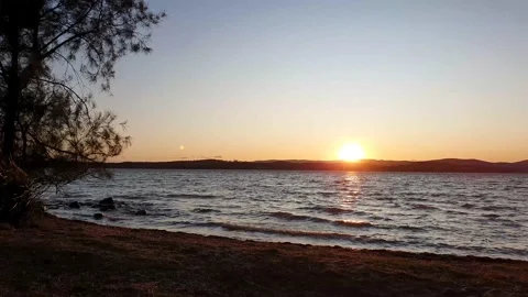 Sunset over the lake on windy day. Waves on the shore line. Stock Footage 211065489