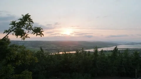 Sunset over the landscape with rivers and hills in the distance Stock Footage 306394274